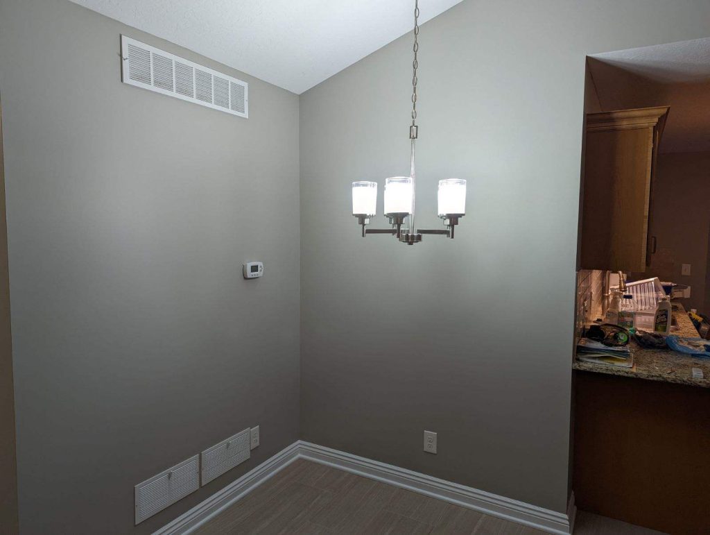 Elegant dining room with gray walls and white trim, professionally painted by Painting by DeAnna, serving Canton and Northeast Ohio.