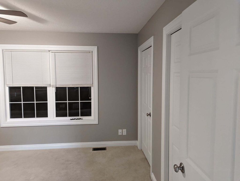 Modern bedroom featuring gray walls and crisp white trim, painted by Painting by DeAnna in Northeast Ohio.